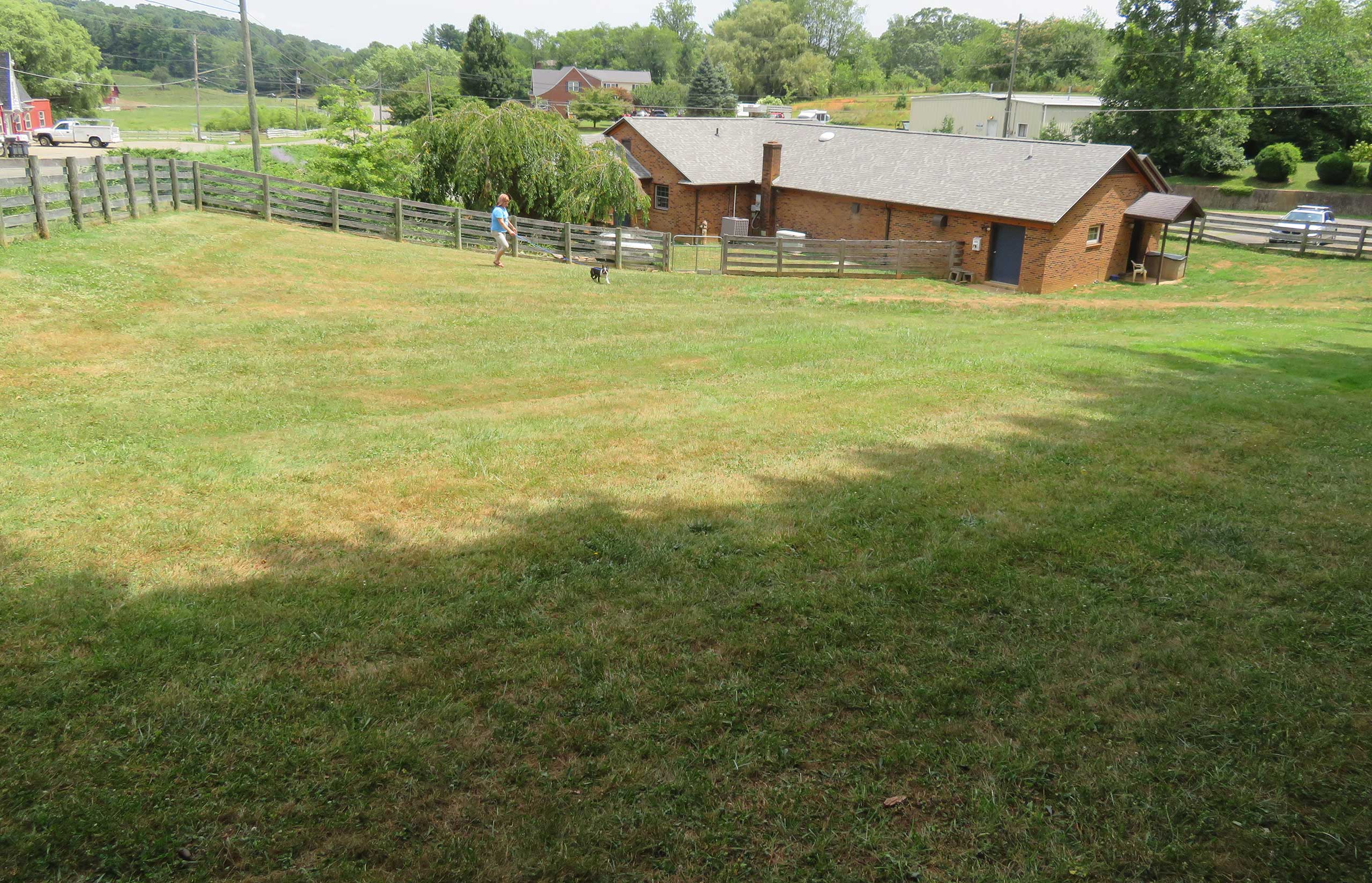 Back of Healing Springs Animal Hospital where dogs boarding with us have time on grass four times daily.
